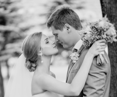 Couple holdiing hands over bouquet