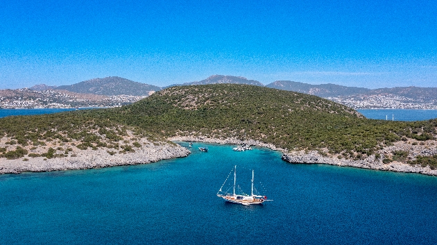 A boat sailing around mountainous islands