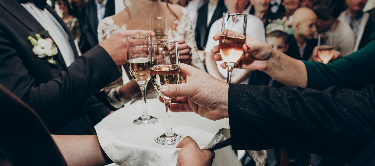 wedding guests with glasses of drink