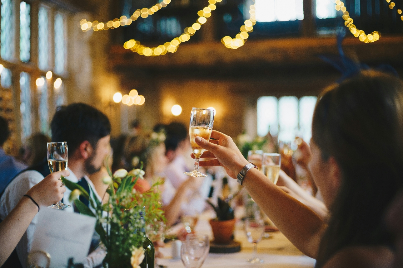 guests at a wedding raising glasses