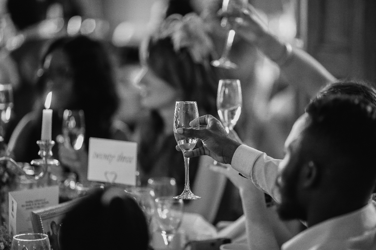 guests raising their glasses at a wedding reception