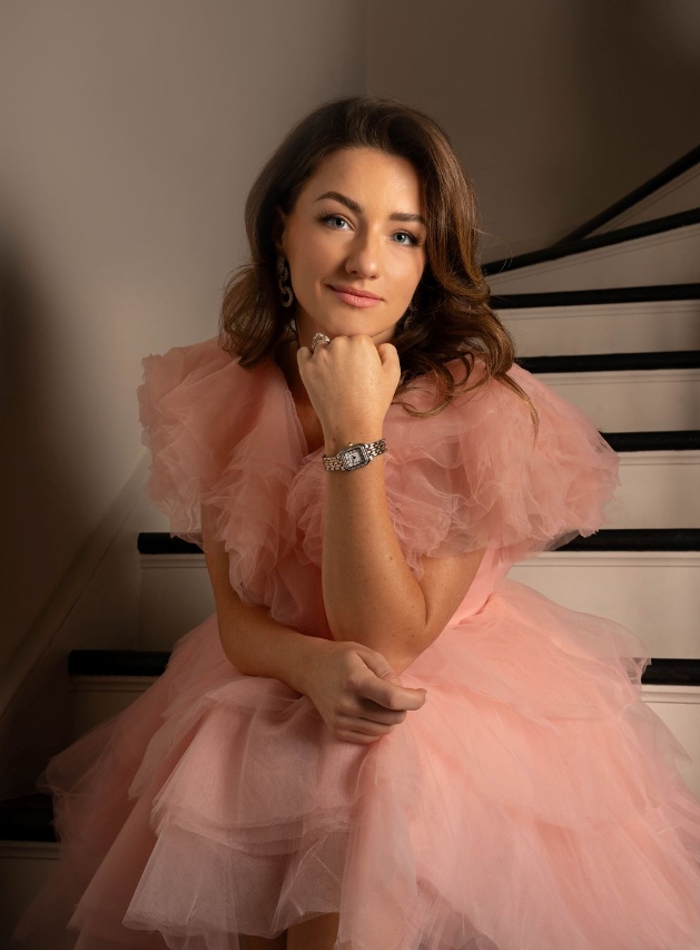 Monica Marriott-Mills in pink dress with watch on 