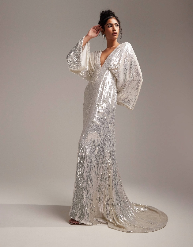 model in full length sequin gown with batwing sleeves