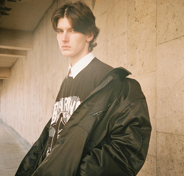 man in black coat and brown sweater