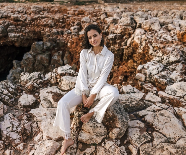 One model in silk pajamas on a rock 