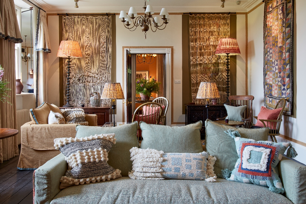 cosy room with sofas and lots of macrame on walls