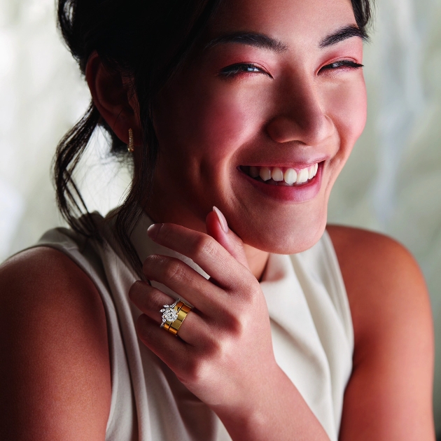 model laughing wearing diamond rings