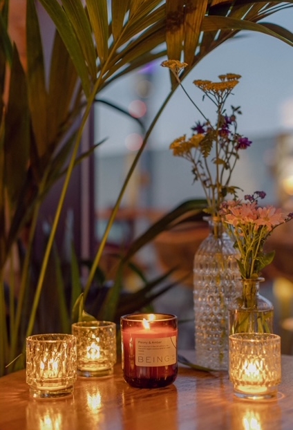 flowers and a candle on a table