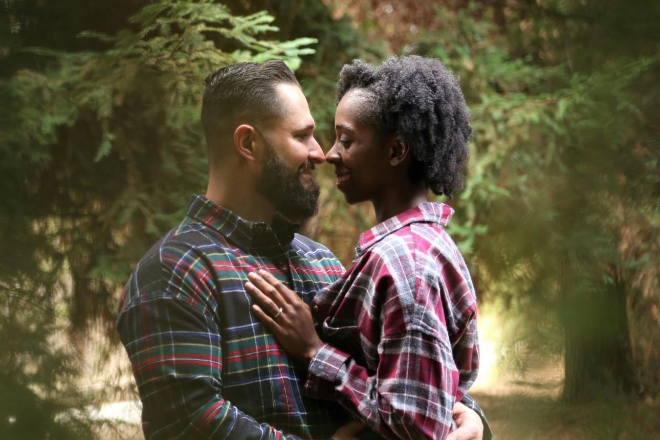 couple engaged in woods embracing