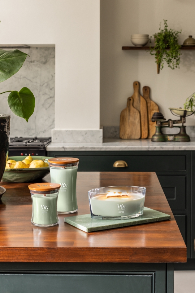 pale green candles in three size in kitchen 