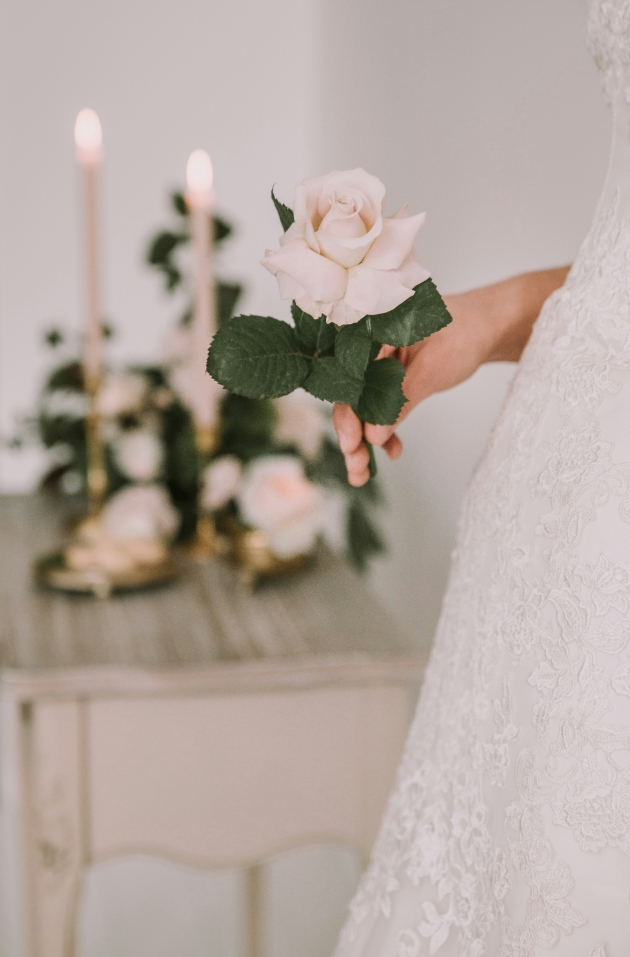 bride holding white rose head